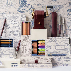 The Caran d'Ache Toile de Jouy collection in front of a wall with the Geneva motif